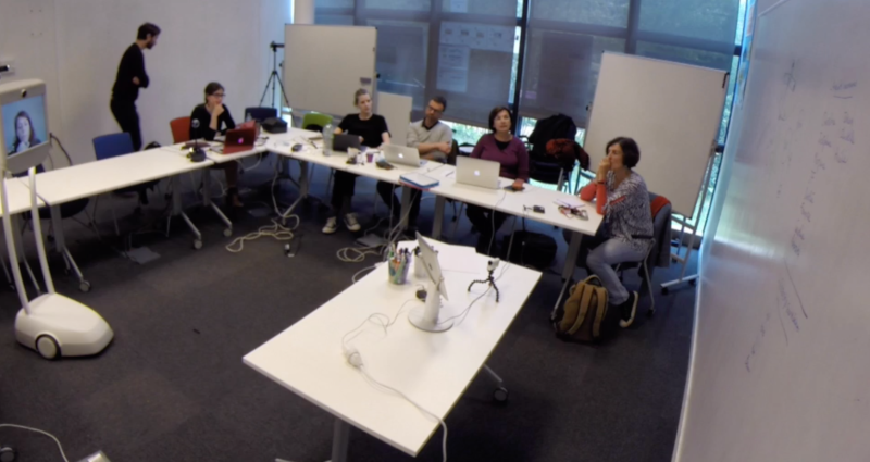 Figure 3: The speaker controls the Beam which is facing the audience, seated at the L-shaped table